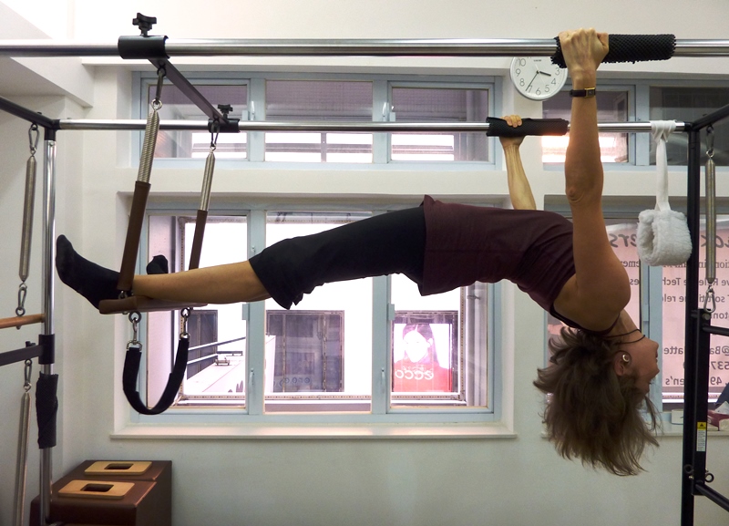 Olga demonstrating Spread Eagle on Pilates Cadillac