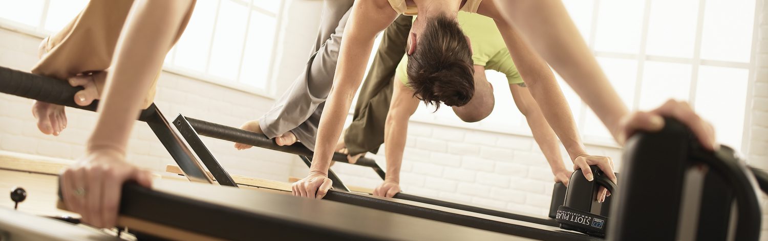 people working out on Pilates Reformer