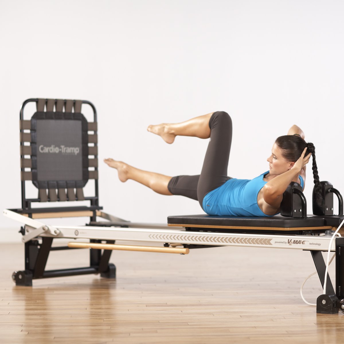 a woman performing Jumping Exercise on Pilates Reformer