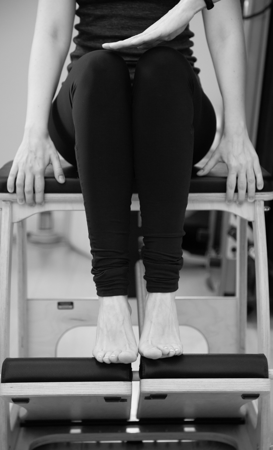 A Pilates practitioner performing an exercise Footwork on Chair